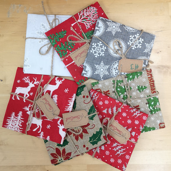 Variety of linen fat quarters with glittery christmas designs.