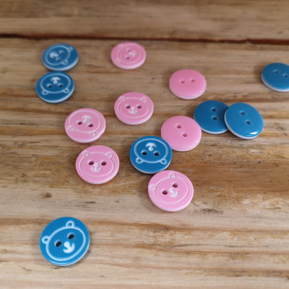 pink and turquoise buttons with bear face imprinted in white
